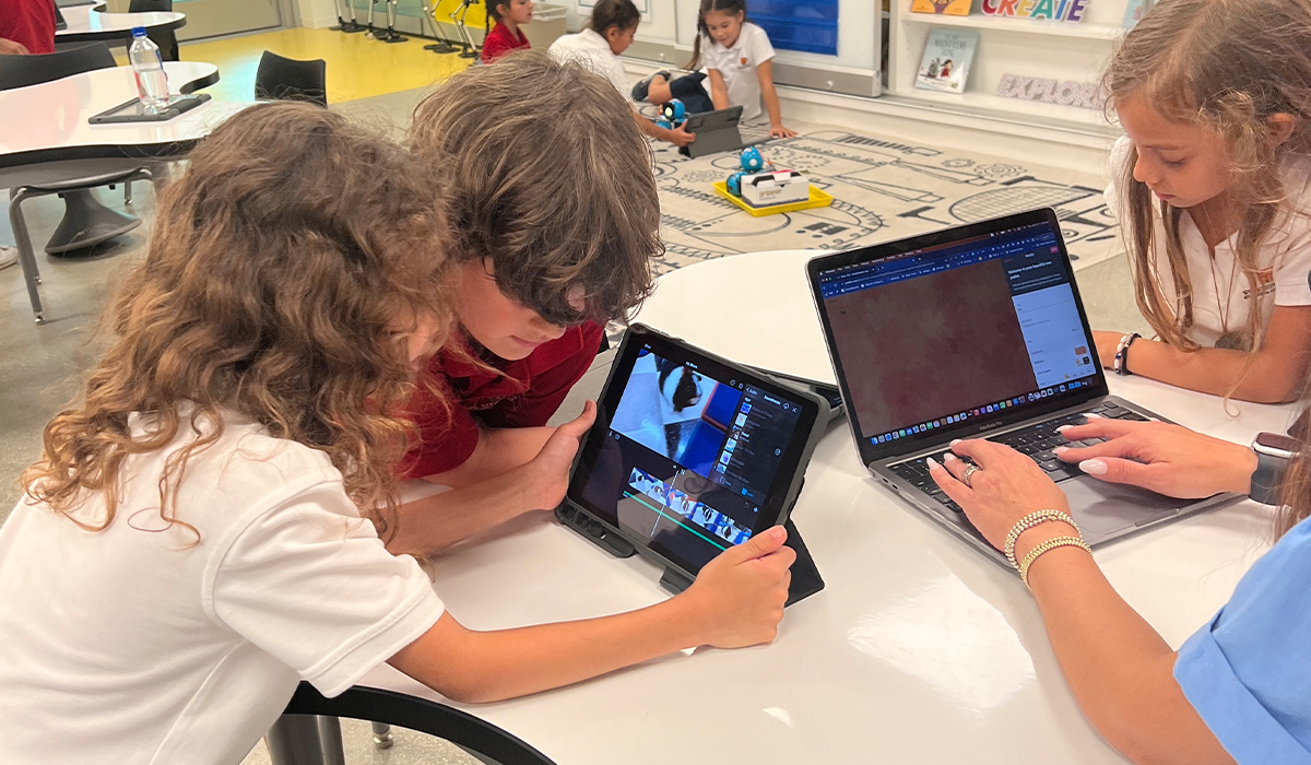 Students researching with iPads and laptops